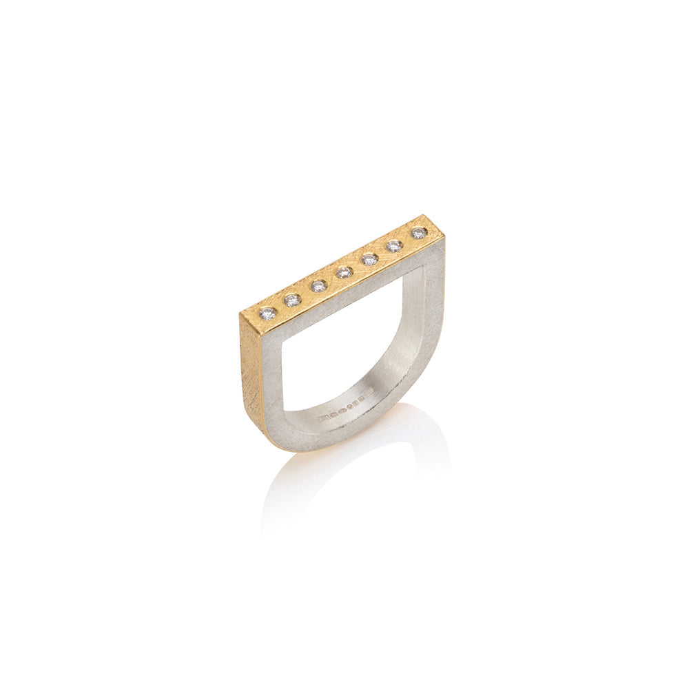 22k yellow gold and sterling silver U-shaped ring with a row of flush set 7 white diamonds, 0.10cttw. Ring is a size 7.75 and can stack with both offset tourmaline rings.