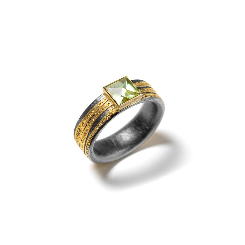 Fancy cut apple green tourmaline, 1.49cts, set on an oxidized sterling silver ring shank with 22k and 24k yellow gold. Ring is 5/16" wide (8mm) and is a size 10.