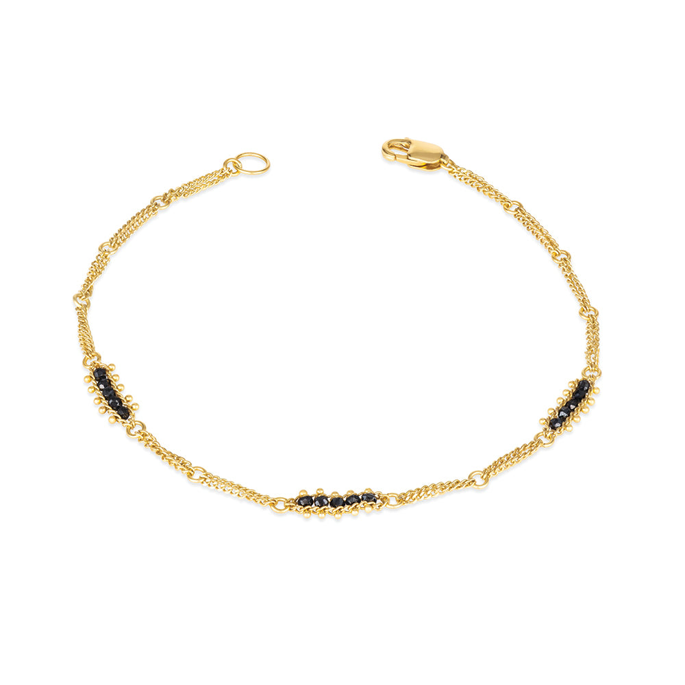 Textile station black diamond bracelet with approximately .70 cttw, in 18k yellow gold with a lobster clasp. Bracelet is 7" long x 3/16" wide (4 mm).
