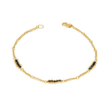 Textile station black diamond bracelet with approximately .70 cttw, in 18k yellow gold with a lobster clasp. Bracelet is 7" long x 3/16" wide (4 mm).