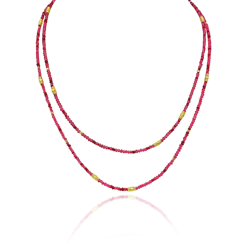 34" long multi-wrap ruby, 6.94 cttw, and red spinel, 25.48 cttw, beaded bracelet with gold beads. Bracelet has a lobster clasp and a 2" extension.