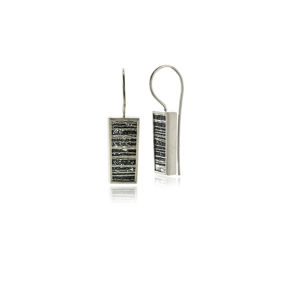 Slim tapered medium drop frame earrings in sterling silver with hand fabricated oxidized silver mesh and horizontal silver accents, on stationary French wires. Earrings are 1 5/16" long x 5/16" ( 33 x 8mm).