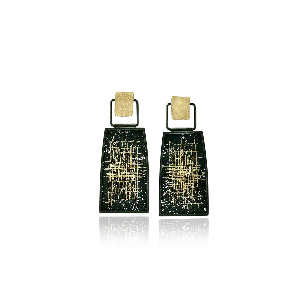 Hinged drop framed earrings in oxidized sterling silver with applied 18k yellow gold detail with studs with post backs, and hand fabricated mesh in oxidized silver and 24k yellow gold patchwork pattern. Earrings are 1 11/16" long x 11/16" wide.