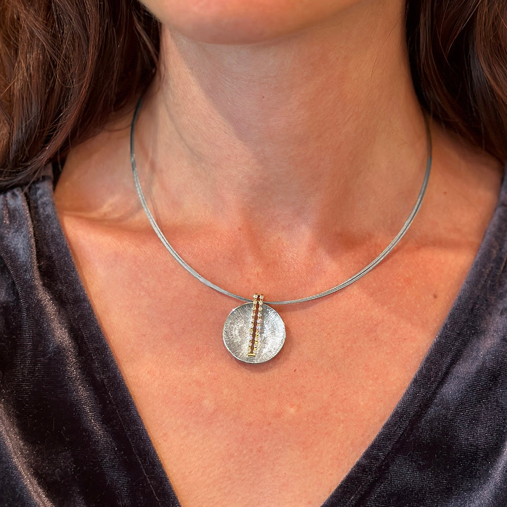 sun dial pendant in platinum and 18k with diamonds