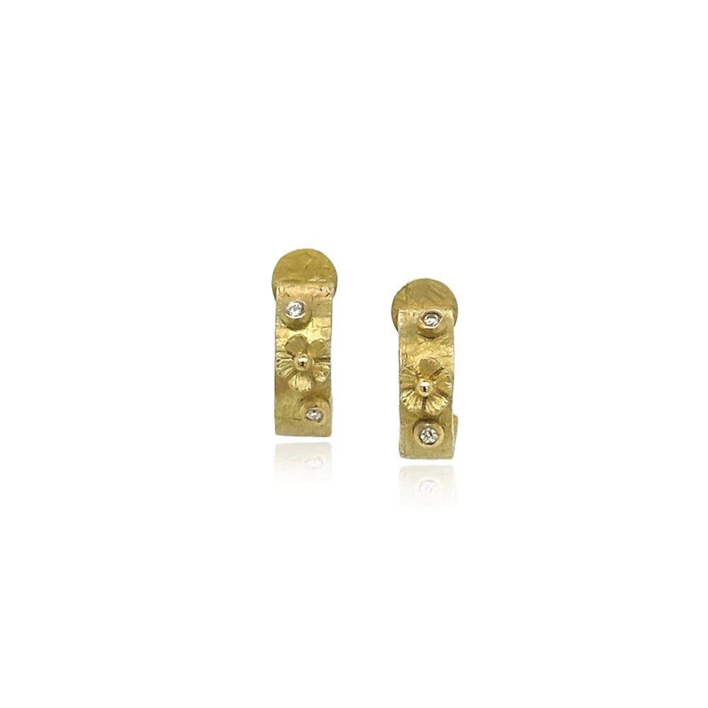 Hand-fabricated, half round hoop earrings in 18k yellow gold with flowers and white diamonds,0.04cttw, and post backs. Earrings are 7/16" in diameter (11mm) and are 4mm wide.