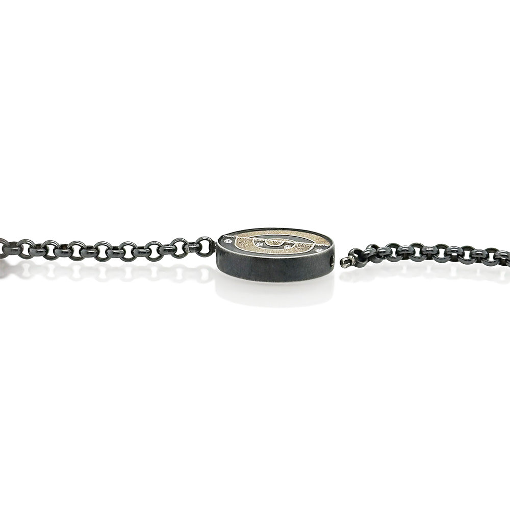 Round Vario clasp in oxidized sterling silver and 12k white gold, with white (G) diamonds, vsi, 0.18 cttw. Clasp is 27mm (1 1/8") diameter and 6mm high.