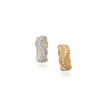 Spur huggie diamond earrings with a reversible lever back setting, one side is 18k yellow gold and the other side is 18k white gold with pavé-set diamonds on both sides, .72 cttw, with a heavy silk finish. Earrings are 1/4" wide x 5/8" diameter (6 x 16mm).