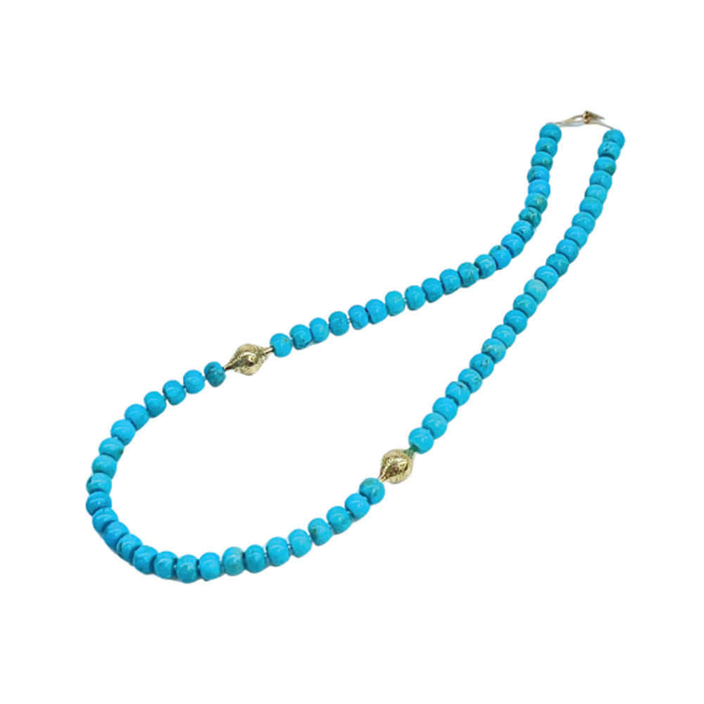 Beaded turquoise necklace, 8mm diameter, finished with two small 18k yellow gold crownwork finials and small lilypad clasp. Necklace is 21.25" long.