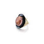 18k yellow gold crownwork "Regency" ring with bezel set oval pink tourmaline center stone, 13.47cts, set in oxidized silver with fired black glass enamel surround. Ring is a size 6.25 and tourmaline is 1" wide (26mm).