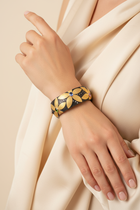 Closed flower cuff worn by a model