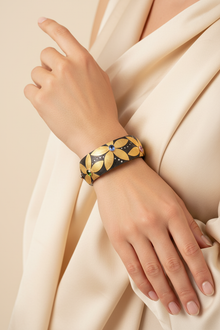 Closed flower cuff worn by a model