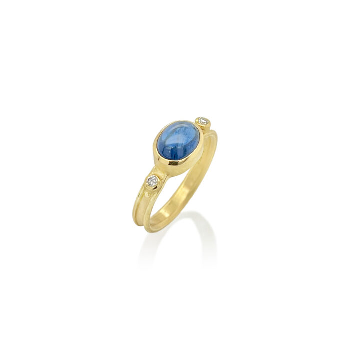 Oval blue cabochon sapphire ring with diamonds