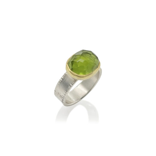 large faceted, high dome peridot ring.