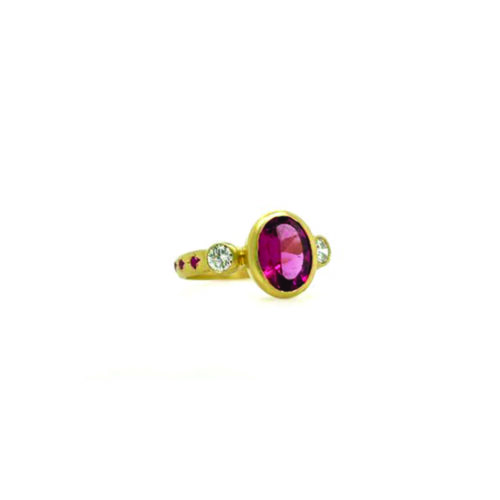 Three-stone ring with rubellite tourmaline, champagne diamonds, and pink sapphires