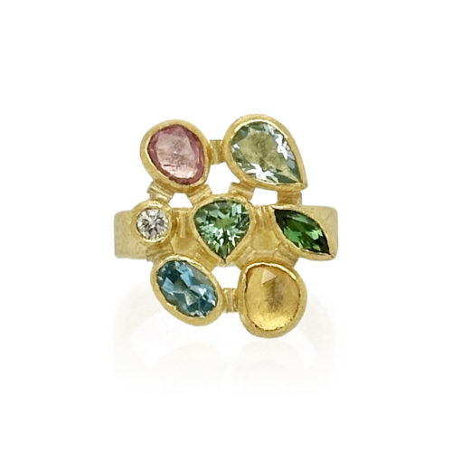Mix of faceted gemstones (aquamarine, diamond, sapphire and tourmaline) set in a mosaic style in 22k gold bezels with 18k gold spacers, backings and a 4mm ring band. Ring size is size 6.5