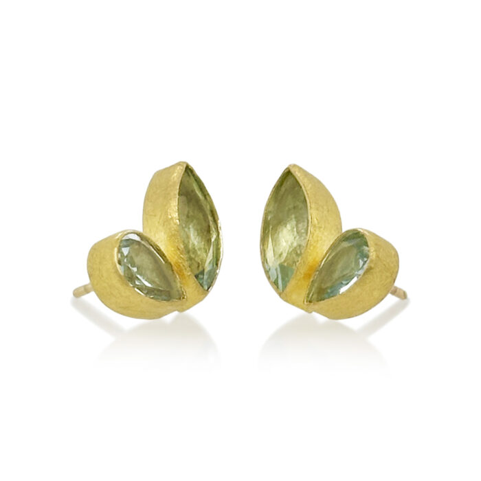 Faceted aquamarine stud-back earrings in mixed cuts and shapes, 4 cttw. Earrings are set in 22k gold bezels with 18k backings and spacers.