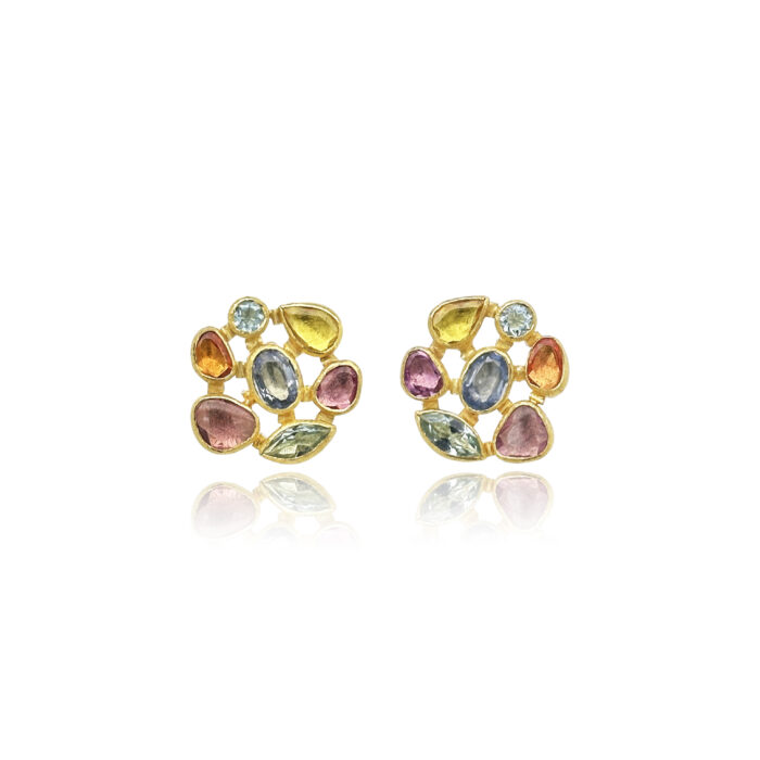 A blend of faceteted mixed cut and shaped stones including aquamarines and sapphires. Earrings are set in 22k gold bezels with 18k backing and spacers, on posts.
