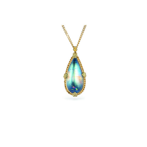One-of-a-kind necklace with an elongated pear- shaped blue-flash moonstone with a rainbow feather inclusion, 6.48cts. Moonstone is 22mm long x 10mm wide with granulation on the bail and prongs. 18k adjustable chain (16"-18") with lobster clasp.