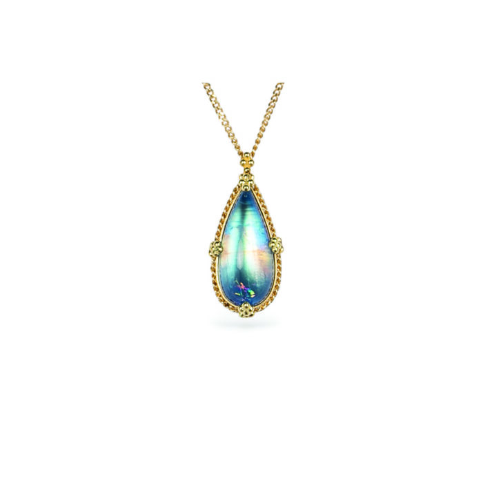 One-of-a-kind necklace with an elongated pear- shaped blue-flash moonstone with a rainbow feather inclusion, 6.48cts. Moonstone is 22mm long x 10mm wide with granulation on the bail and prongs. 18k adjustable chain (16"-18") with lobster clasp.