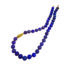 Beaded Tanzanite necklace, 10mm diameter, finished with an 18k yellow gold tapered crownwork link and small lilypad clasp. Necklace is 19" long.