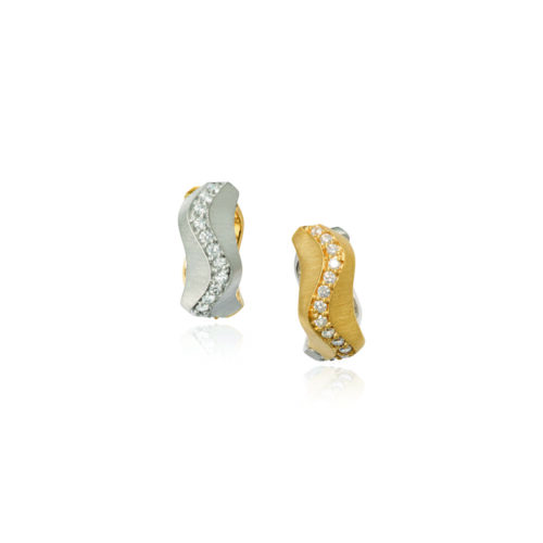 Spur huggie diamond earrings with a reversible lever back setting, one side is 18k yellow gold and the other side is 18k white gold with pavé-set diamonds on both sides, .72 cttw, with a heavy silk finish. Earrings are 1/4" wide x 5/8" diameter (6 x 16mm).