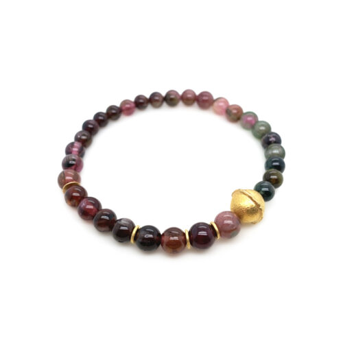"Cateye" tourmaline bracelet, 49.2 cttw, ranging in color from dark blue to dark pink, with 18k yellow gold spacers and round charm.