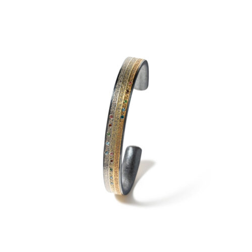 Small striped cuff in oxidized sterling silver with 19k and 24k yellow gold and fancy-colored diamonds, 0.15cttw. Cuff is 5 1/2" in circumference and is 5/16" wide (8mm).