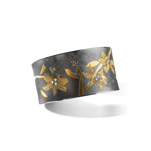 Oxidized sterling silver "Lily" cuff with 24k yellow gold, white (G) vs diamonds, 0.09cttw, green diamonds, 0.03cttw and redish-brown diamonds. Cuff is 6 3/4" in circumference and is 1 1/4" wide (32mm).