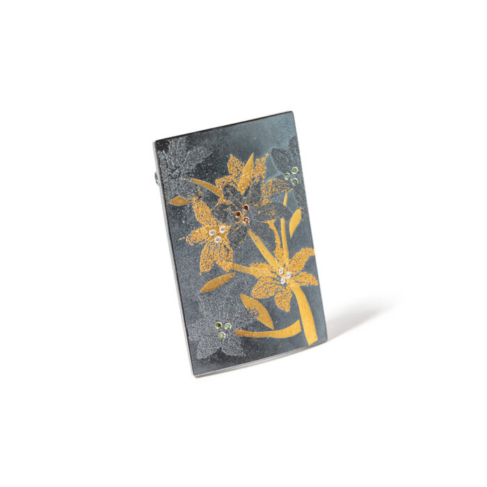 Rectangular Oxidized sterling silver "Lily" pendant with 24k gold, white (G) vs diamonds, 0.06cttw, green diamonds, 0.06cttw and reddish-brown diamonds, 0.03cttw. Pendant can be worn on a chain or cable and also with the Vario clasp system. Pendant is 2 1/4" long x 1 1/2" wide (5.7cm x 38mm).