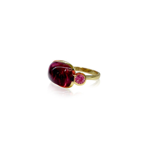 18k yellow gold crownwork, three-stone scallop ring with bezel-set pink tourmaline center stone, 8.35 cts, and pink sapphire side stones, 0.63 cttw. Ring is a size 6.5 and is 3/4" x 1/2".