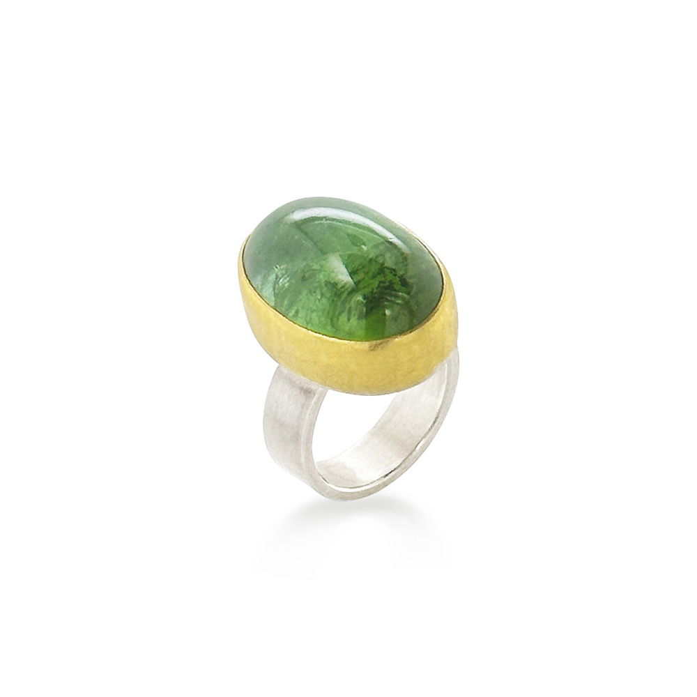 Oval cabochon green tourmaline set in 22k yellow gold and a sterling silver ring shank. Tourmaline is 17 x 22mm and ring is a size 7.