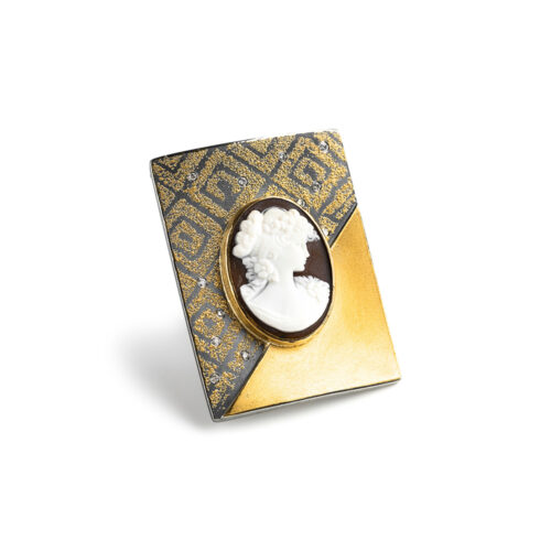 Cameo brooch in oxidized sterling silver, 18k, 22k and 24k yellow gold with scattered white (G) diamonds, vs, 0.12 cttw. Brooch has a bar pin with loop and is 1 13/16" long x 1 3/8".