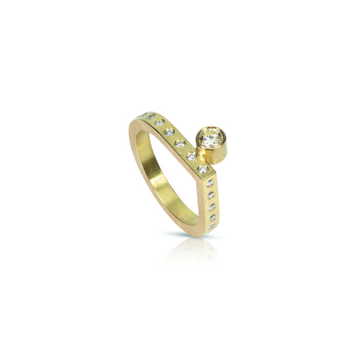 18k yellow gold ring with a brilliant cut round diamond, 3.81mm, 0.21 ct, with 25 flush-set diamonds on the surface, .20cttw. Ring is a size 7.