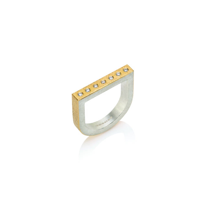 22k yellow gold and sterling silver U-shaped ring with a row of flush set 7 white diamonds, 0.10cttw. Ring is a size 7.75 and can stack with both offset tourmaline rings.