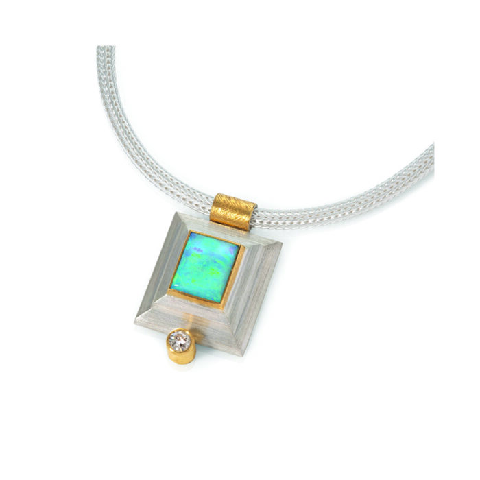 24k yellow gold and sterling silver step bezel pendant with rectangular Australian Bolder opal, 3.33 cts, and a round diamond, 0.24ct. Pendant is on a woven sterling silver chain.