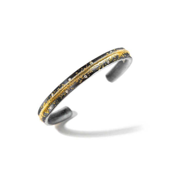 Oxidized sterling silver cuff with a center rail, with 24k gold, vs white (G) diamonds, 0.08cttw, size medium, 6.5" interior dimension.