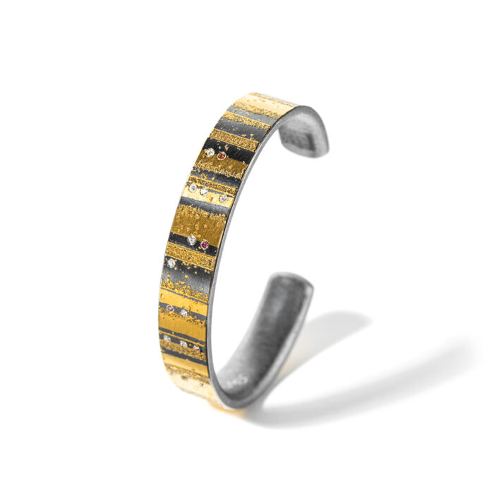 Medium oxidized sterling silver cuff with 24k yellow gold stripes, white (G) diamonds, 0.13cttw, pink diamonds, 0.05cttw. Cuff is 7/16" wide (12mm) and has an interior dimension of 6.25"