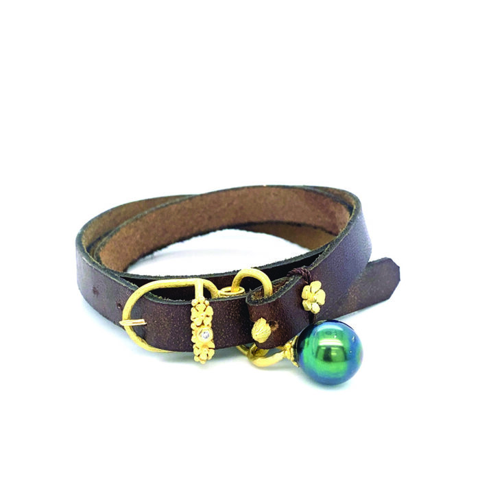 Leather wrap bracelet with adjustable 18k yellow gold buckle, floral, mushroom and diamond accents, 0.03ct, and a Tahitian pearl.