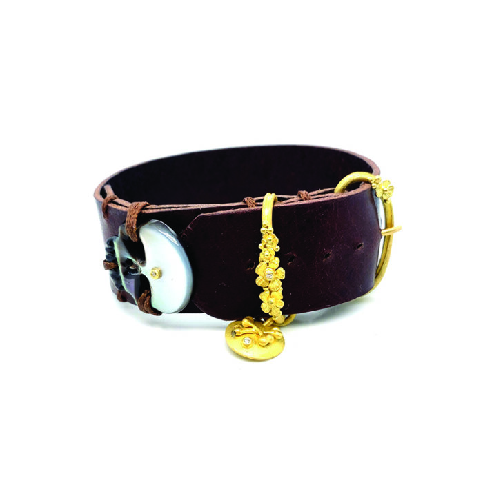 Leather wrap bracelet with adjustable 18k yellow gold buckle, floral and crossbones accents with diamonds, 0.03cttw, and a Mother of Pearl skull.