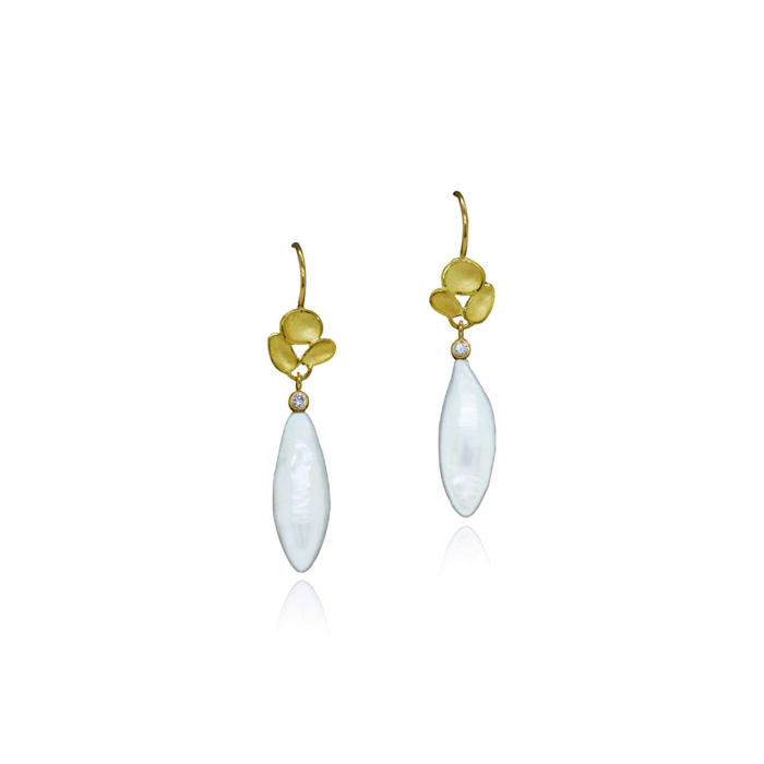 Elongated drop-shaped white freshwater pearl drop earrings with small diamonds and triple shell cluster tops in 18k yellow gold, on French wires. Pearl drops are 7/8" x 5/16" (21 x 8mm) and total length is 19/16" (40mm). 