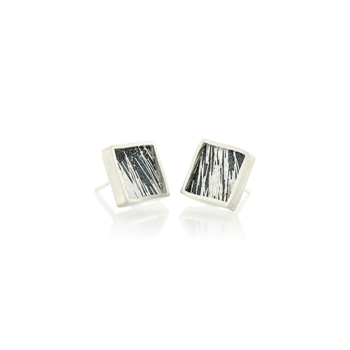 Small framed square studs in sterling silver with hand fabricated mesh in oxidized silver and gold. Earrings are 7/16" (12mm).