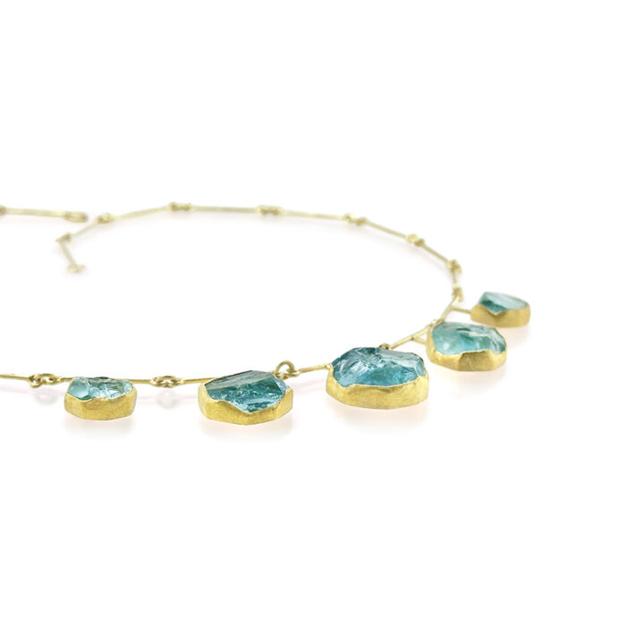 Five round, natural surface aquamarine crystals, 37 cttw, set in 22k yellow gold bezels with 18k yellow gold backings and segment chain, 18" long with S-hook clasp.