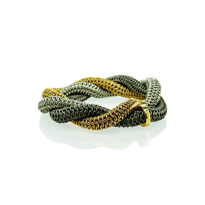 "Tryst" bracelet in 18k yellow gold, titanium and sterling silver, with a diamond runner. Bracelet has a 7 1/4" circumference. 