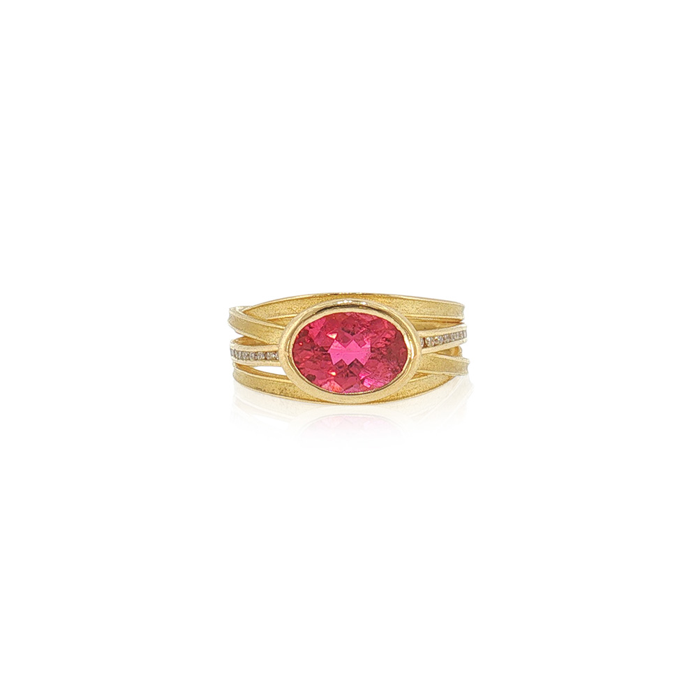 two-tiered oval pink tourmaline ring with 4 blades and channel set diamonds in the central blades